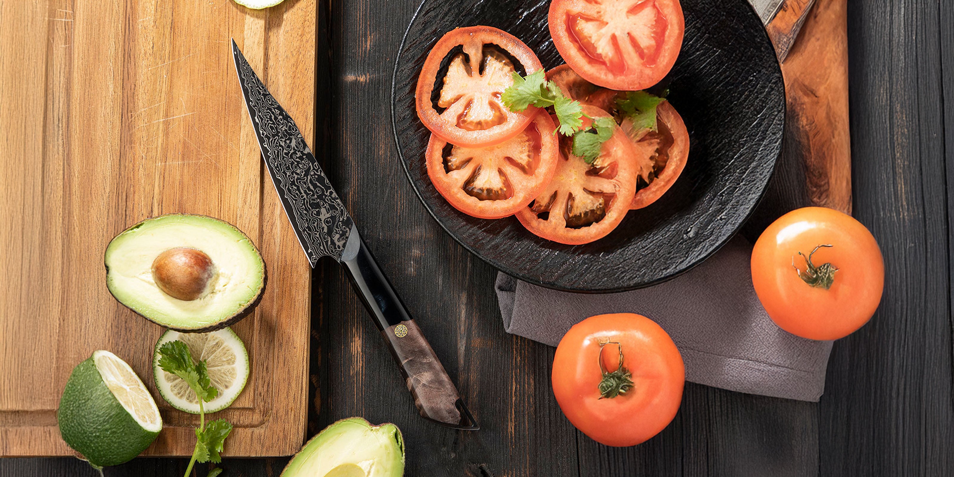 Damascus Utility blade with Wooden Handle on Cutting Board Surrounded by Fresh Tomatoes