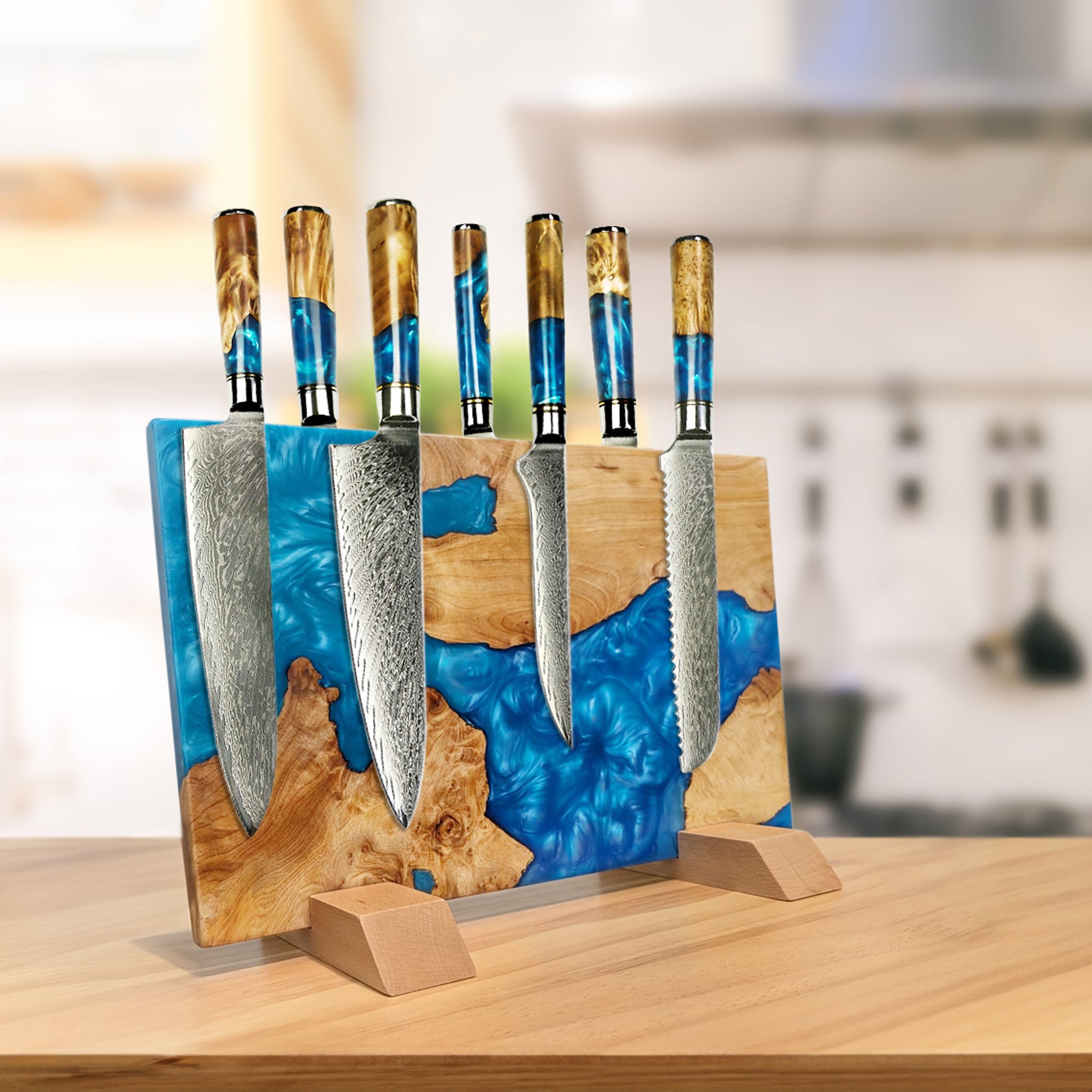 Set of knives with wooden handles and a blue resin blade holder on a wooden surface.