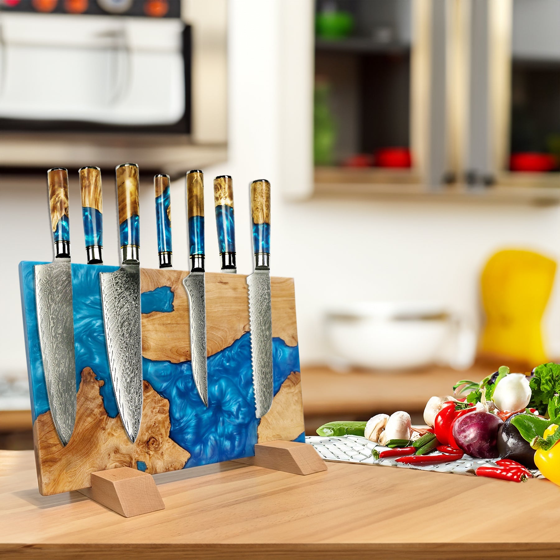 Set of knives in a decorative stand on a kitchen counter with vegetables.